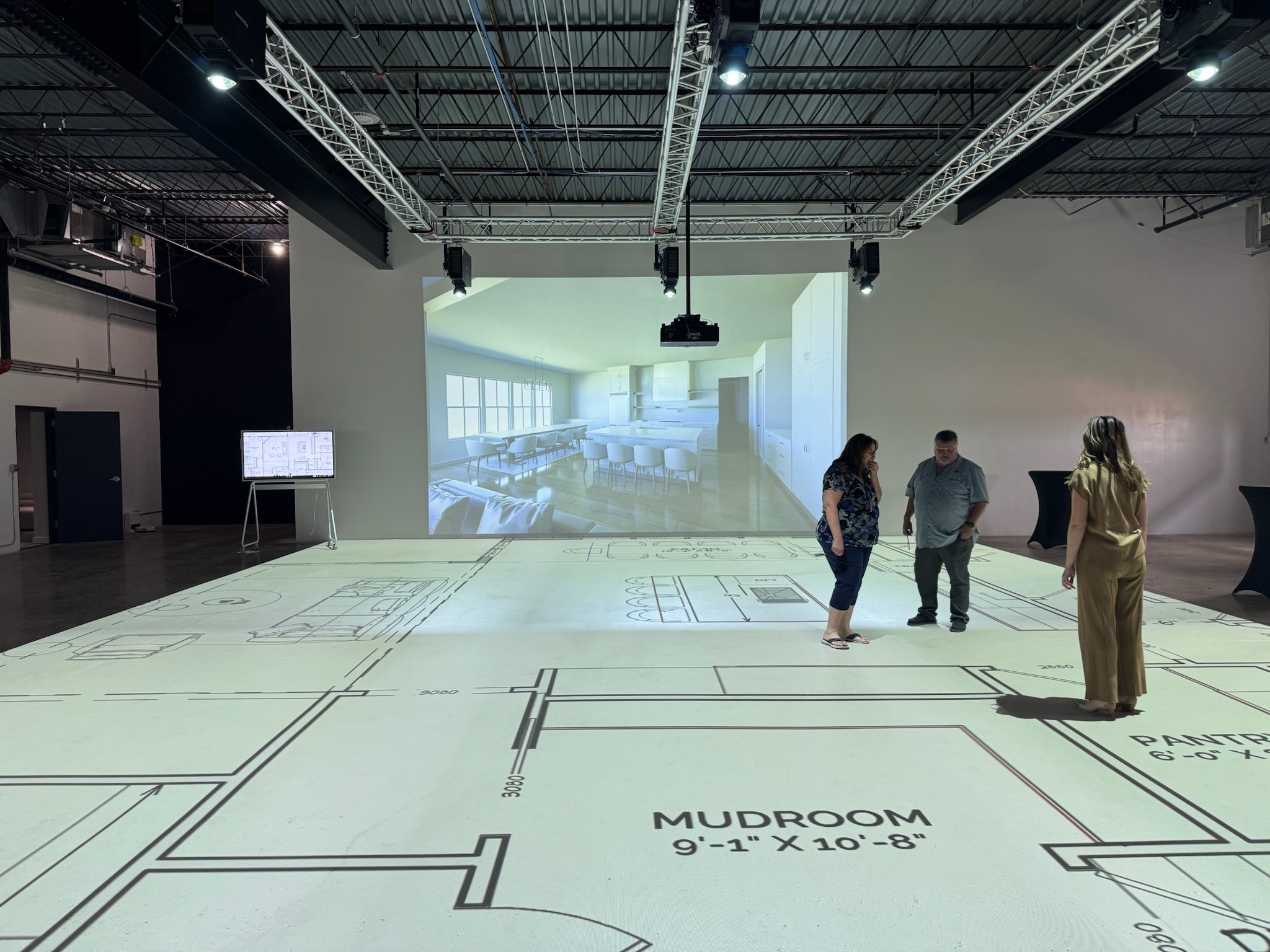 Walk Your Plans session in action — clients walking a projected floor plan