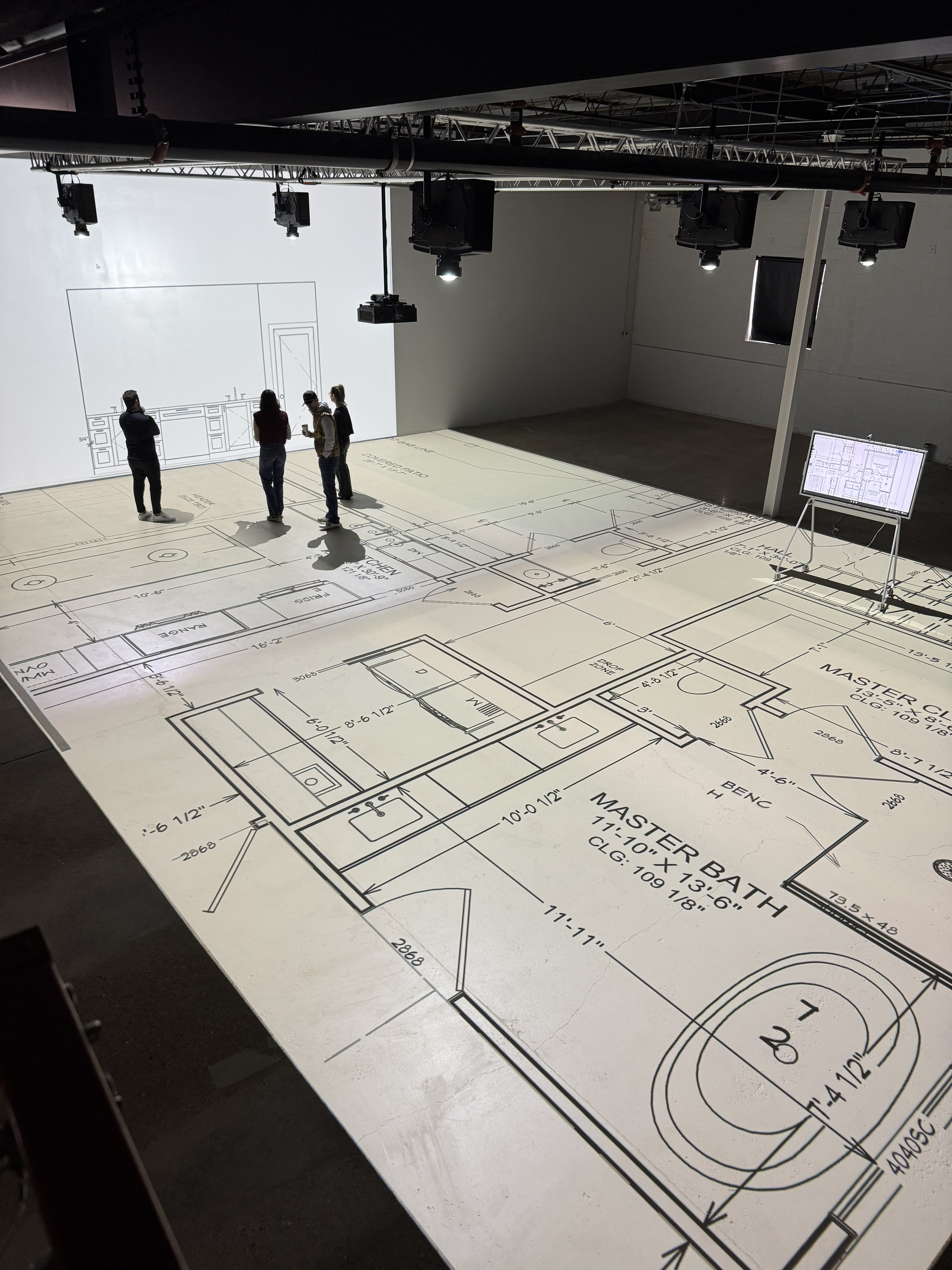 Walk Your Plans projection technology — floor plan projected at full scale