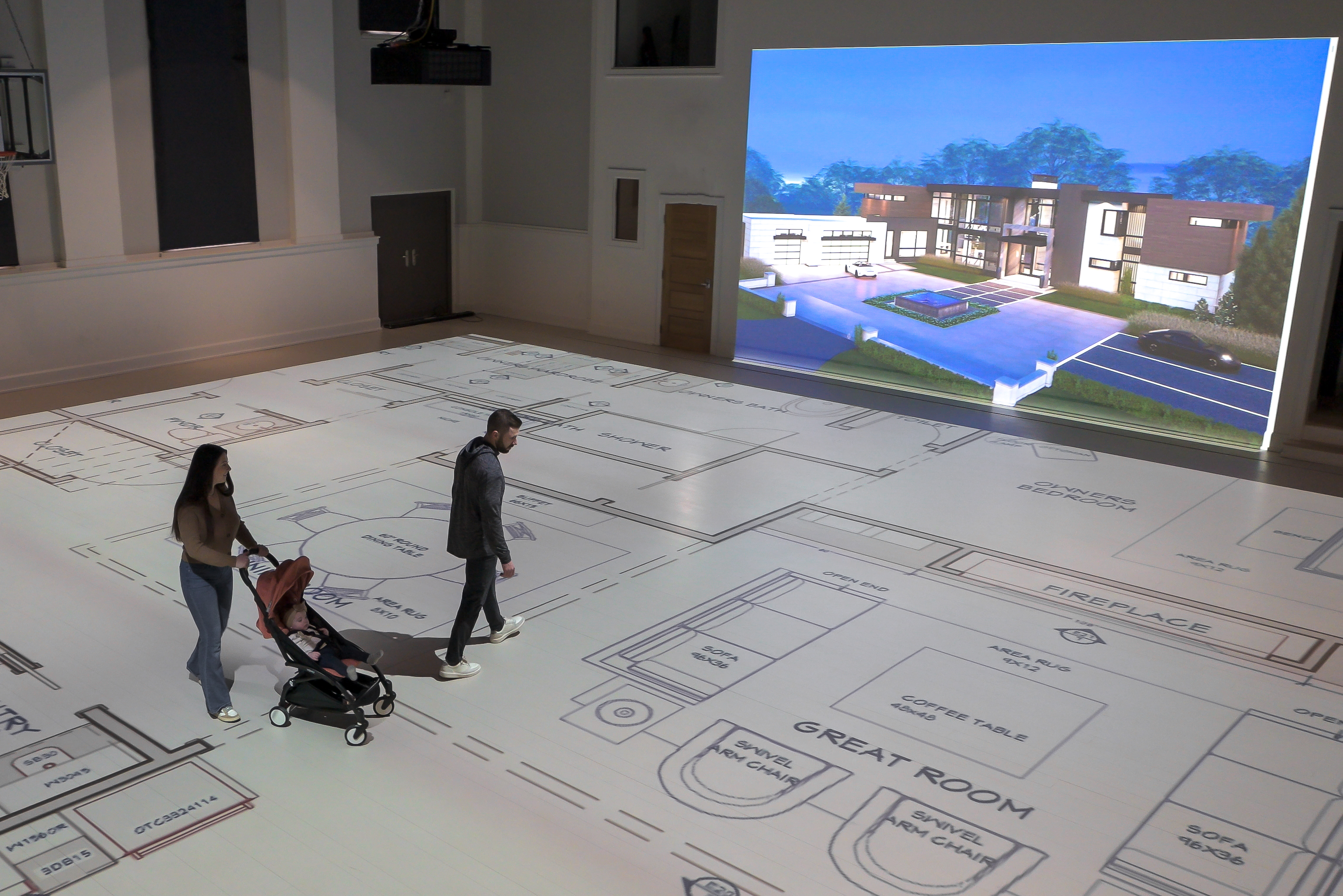 Clients walking through a projected floor plan at Walk Your Plans St. Louis